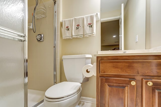 bathroom featuring vanity, toilet, and a shower with door