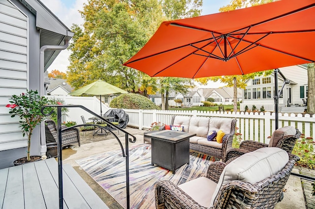 wooden deck with outdoor lounge area and a patio