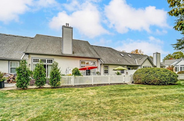 back of house with a lawn