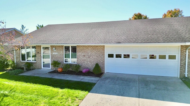 ranch-style house featuring a front yard and a garage