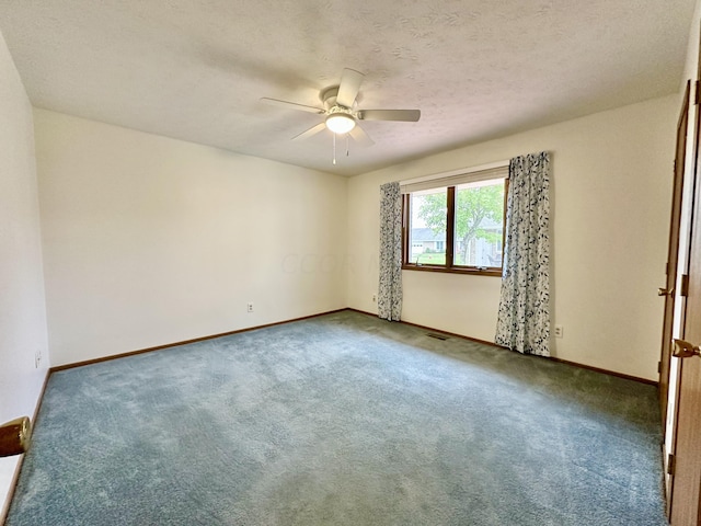 empty room with ceiling fan, carpet, and a textured ceiling