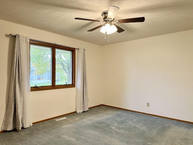 unfurnished room with carpet flooring, ceiling fan, and a textured ceiling