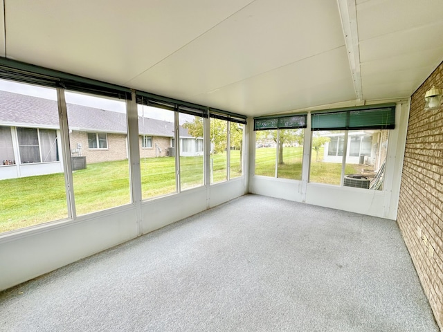 unfurnished sunroom with a healthy amount of sunlight and vaulted ceiling