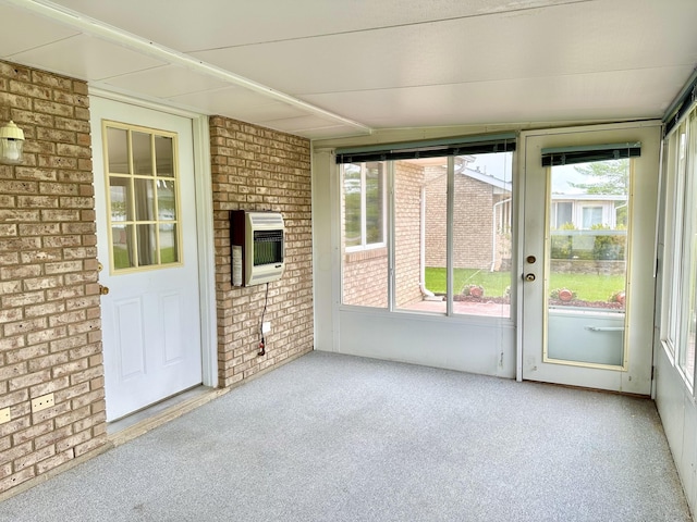 unfurnished sunroom featuring heating unit