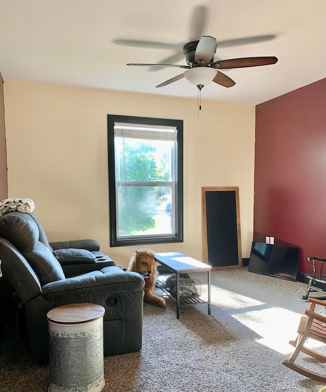 carpeted living room with ceiling fan