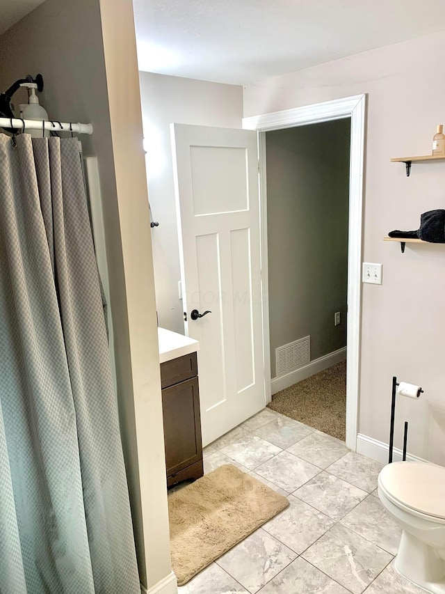 bathroom featuring vanity and toilet