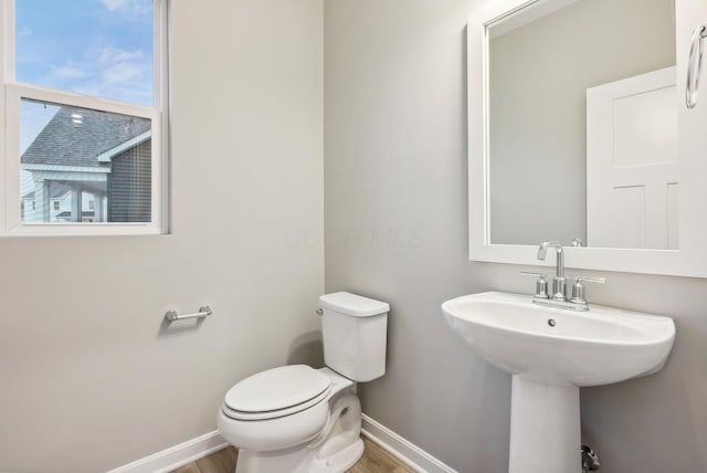 bathroom featuring hardwood / wood-style floors and toilet