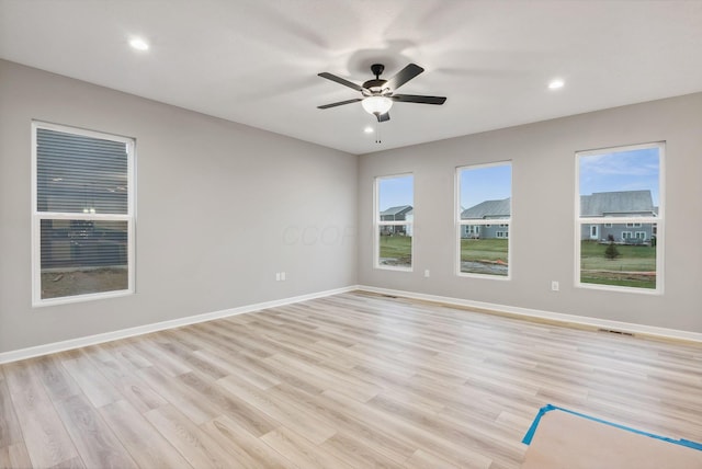 spare room with ceiling fan and light hardwood / wood-style flooring