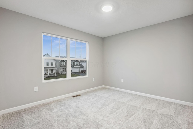 unfurnished room featuring carpet floors