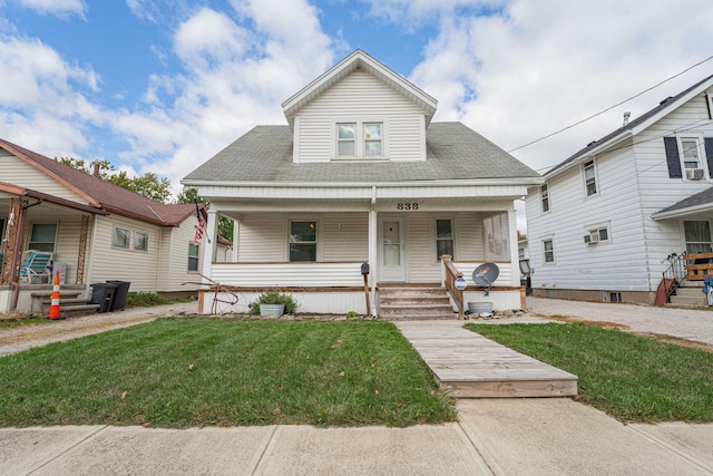 bungalow-style house with a porch and a front lawn