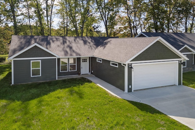 single story home featuring a garage and a front lawn