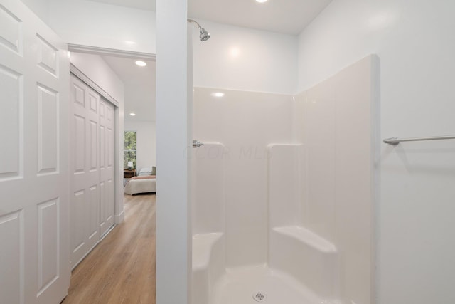 bathroom featuring wood-type flooring and walk in shower