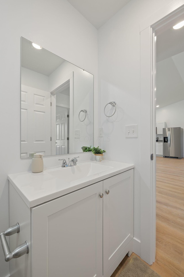 bathroom with vanity and wood-type flooring