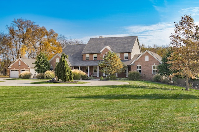 10492 Allen Rd, Pickerington, OH 43147 - view of front of home featuring a front lawn, curved driveway, brick siding, and a garage