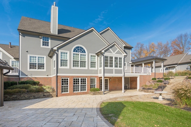 10492 Allen Rd, Pickerington, OH 43147 - back of house featuring a patio, a chimney, and brick siding