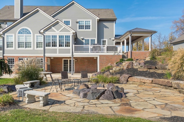 10492 Allen Rd, Pickerington, OH 43147 - back of property with a patio area, brick siding, a chimney, and an outdoor fire pit