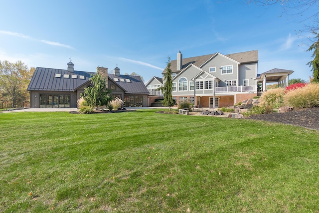 10492 Allen Rd, Pickerington, OH 43147 - rear view of house with a standing seam roof, a lawn, a metal roof, and a chimney