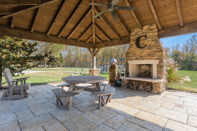 view of patio / terrace featuring a gazebo, an outdoor stone fireplace, and ceiling fan