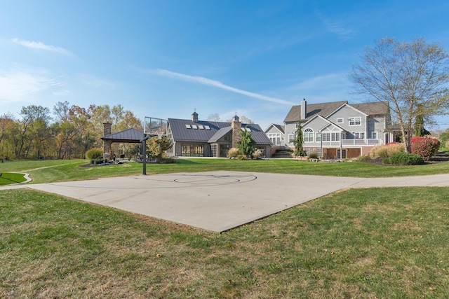 view of basketball court with a gazebo and a yard