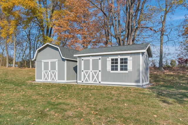 view of outbuilding featuring a yard