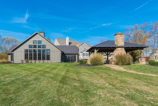 rear view of property featuring a lawn