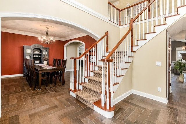 stairs featuring parquet flooring, crown molding, and a notable chandelier