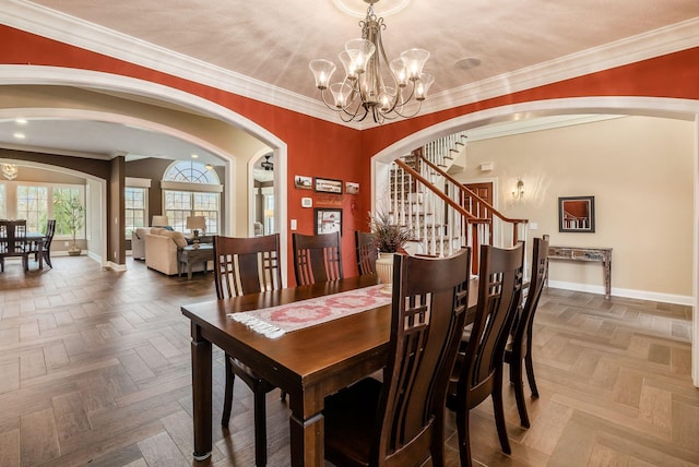 10492 Allen Rd, Pickerington, OH 43147 - dining area featuring arched walkways, a chandelier, stairway, and crown molding