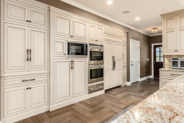 kitchen with black microwave, light stone countertops, dark parquet floors, cream cabinetry, and ornamental molding