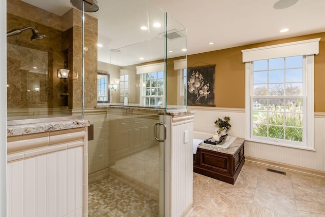 bathroom featuring walk in shower and a wealth of natural light