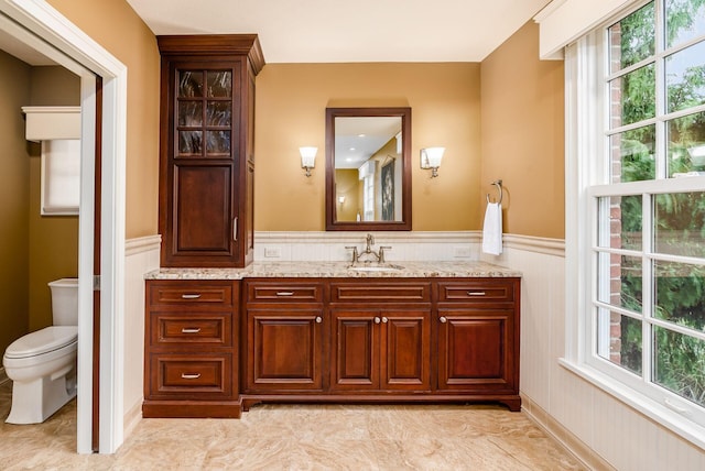 10492 Allen Rd, Pickerington, OH 43147 - bathroom featuring vanity, a wainscoted wall, plenty of natural light, and a decorative wall