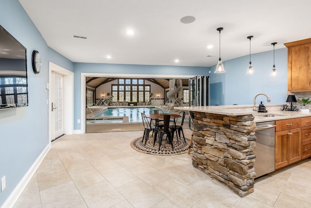 10492 Allen Rd, Pickerington, OH 43147 - kitchen featuring stainless steel dishwasher, brown cabinetry, open floor plan, pendant lighting, and recessed lighting