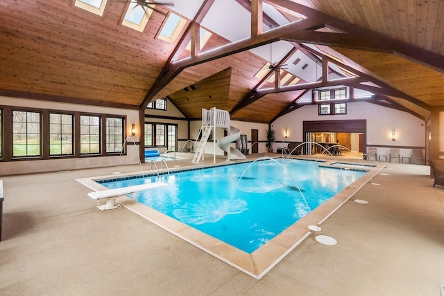 view of pool with a skylight, a diving board, and ceiling fan