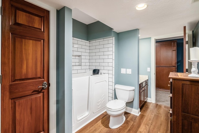 10492 Allen Rd, Pickerington, OH 43147 - full bath featuring vanity, wood finished floors, a bath, and a textured ceiling