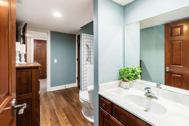 bathroom featuring vanity, hardwood / wood-style flooring, and toilet