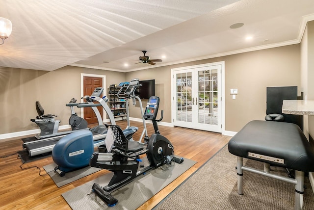 exercise room with ceiling fan, french doors, crown molding, and light wood-type flooring