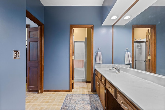 bathroom featuring vanity and a shower with door