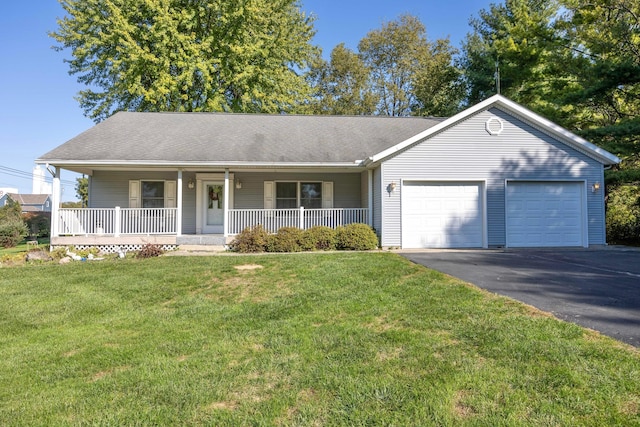 ranch-style house with covered porch, a garage, and a front lawn