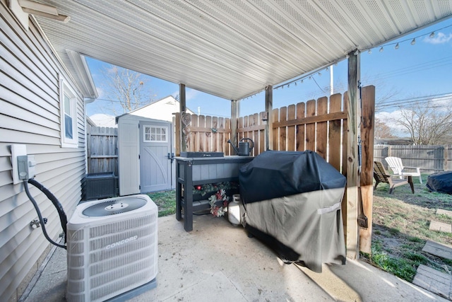 view of patio with a storage unit, a grill, and central air condition unit