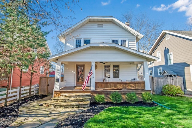 view of front of property with covered porch and a front yard