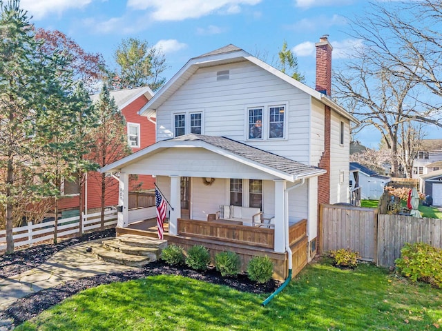 view of front of home featuring covered porch and a front yard