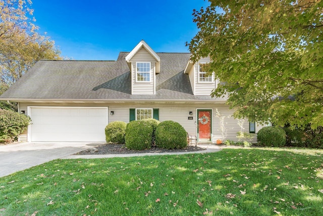 cape cod home featuring an attached garage, a shingled roof, a front lawn, and concrete driveway