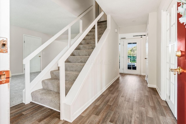 entrance foyer featuring stairway, baseboards, and wood finished floors