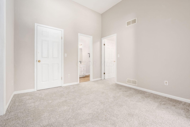 unfurnished bedroom featuring carpet, visible vents, and baseboards