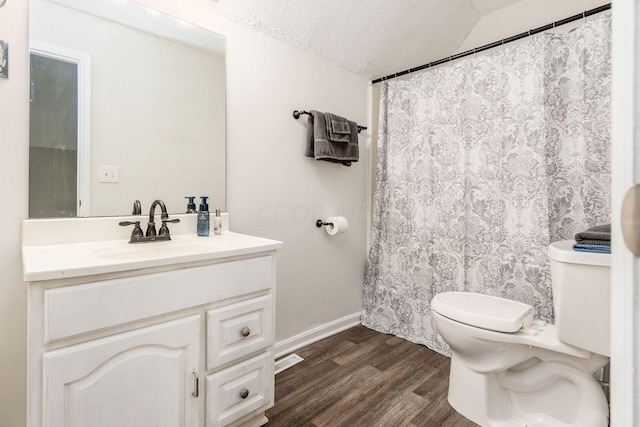 full bathroom with a textured ceiling, toilet, wood finished floors, vanity, and baseboards