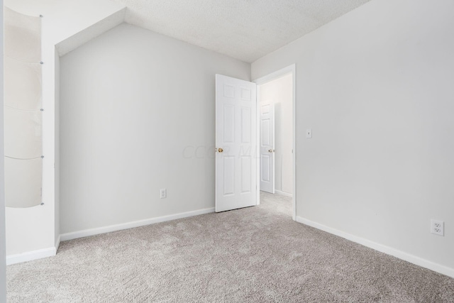 unfurnished bedroom featuring a textured ceiling, baseboards, and carpet flooring