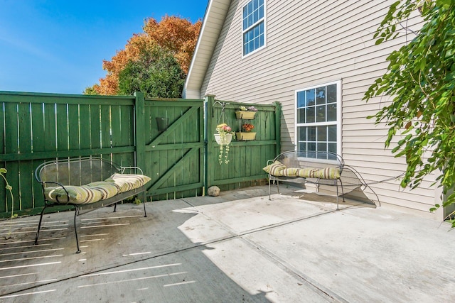 view of patio with a gate and fence