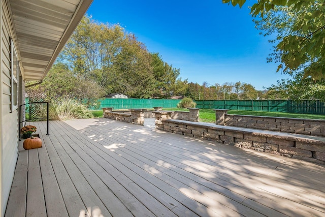 wooden deck featuring a fenced backyard