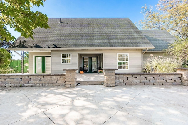 back of house with a patio, french doors, and a shingled roof