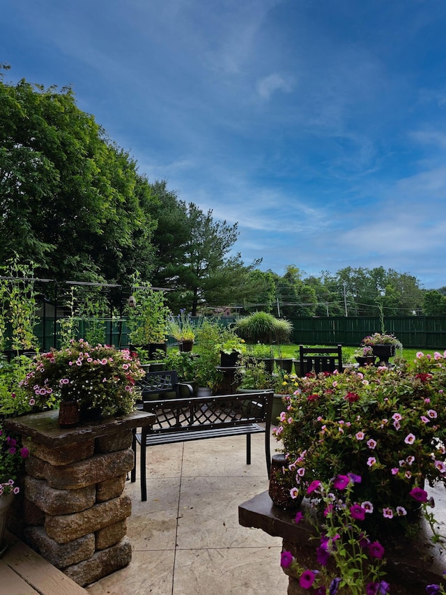 view of home's community with fence and a patio