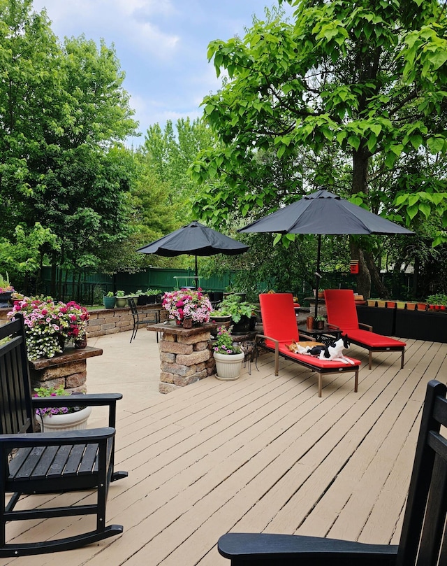 wooden terrace featuring outdoor dining area and fence